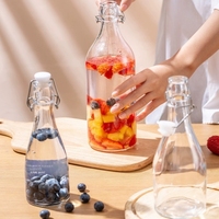 Vente à chaud Big Belly 350ml 500ml 750ml 1000ml Bouteille d'eau ronde en verre transparent Bouteilles de boisson en verre à dessus pivotant avec bouchons