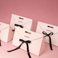 Boîte à dragées blanche personnalisée avec logo, nœud en satin noir et finition mate pour mariage