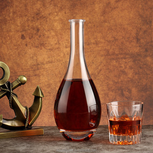 Bottiglia <span class=keywords><strong>di</strong></span> <span class=keywords><strong>Vetro</strong></span> per Brandy XO da 500ml/750ml a Forma <span class=keywords><strong>di</strong></span> Goccia d'Acqua con Superficie Ondulata Bianca Trasparente Sigillata con Tappo in Sughero per Vini e Distillati - Product Image 1
