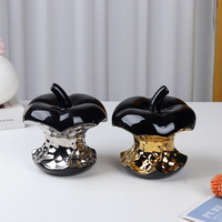 Ornement en céramique en forme de noyau de pomme noir avec détails dorés et argentés, sculpture décorative créative pour la maison, cadeau pour table ou étagère de salon