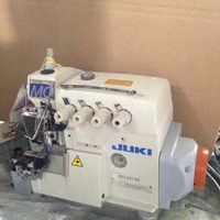 Machine à coudre industrielle JUKIS 6714 à quatre fils d'occasion en bon état