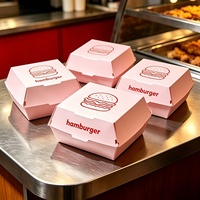 Kartonnen hamburgerdozen in lichtroze kleur met burger-schetslogo, wegwerpbaar, food grade, voor afhaalmaaltijden, fastfoodverpakkingen