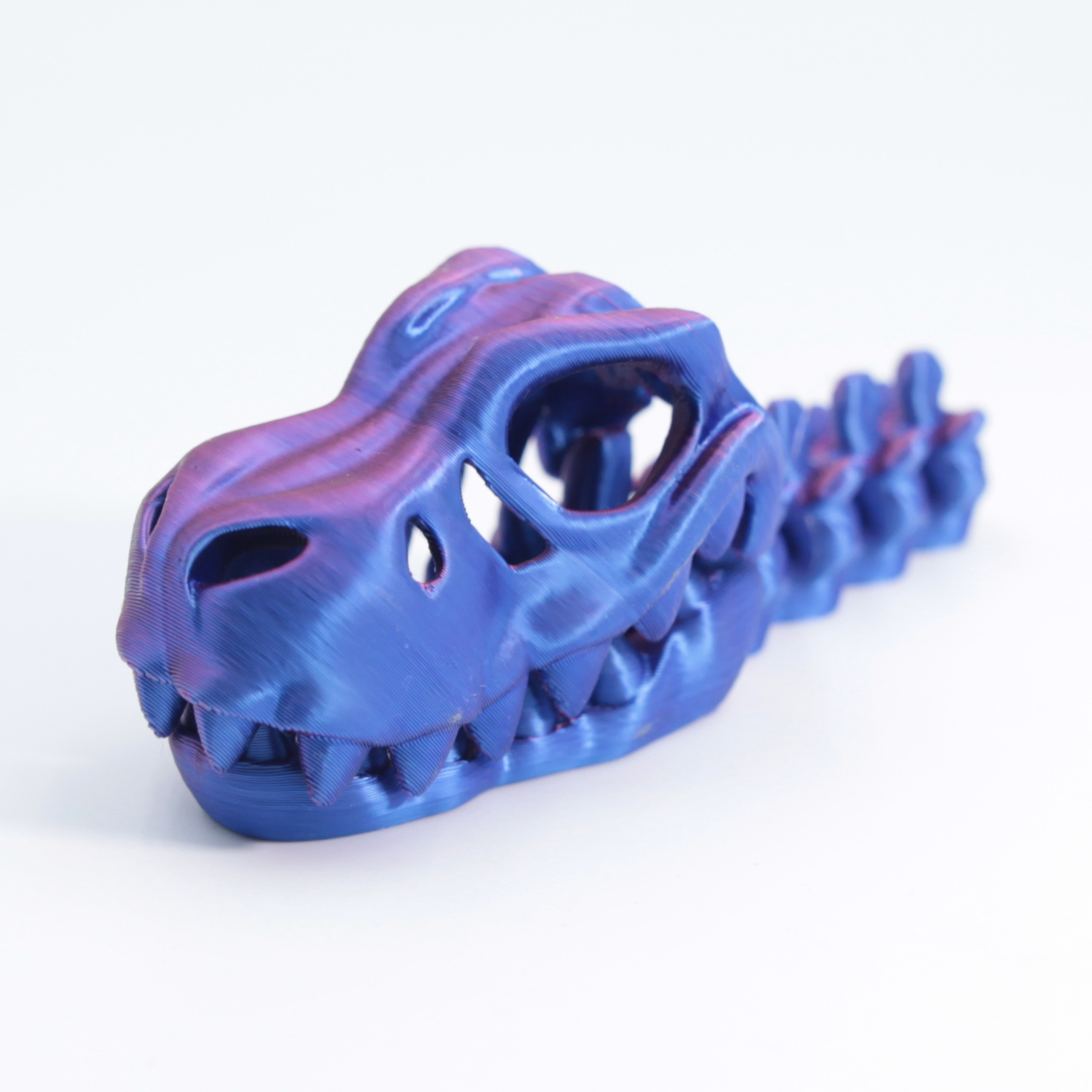Pendentif tyrannosaure rouge et bleu 9cm