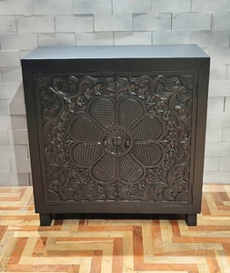 Black rustic wooden storage cabinet with carved floral door and solid wood frame