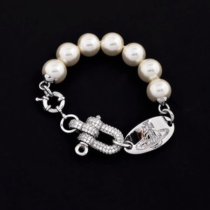 Pulsera y Collar Unisex de Alta Gama con Cuentas de Perlas Saturno y Hebilla en Forma de Herradura en U con Diamantes Completos, Estilo Emperatriz Viuda Vivienne - Product Image 1