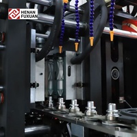 Nouvelle souffleuse de bouteilles PET semi-automatique Fuxuan à 4 cavités avec contrôle PLC et composants essentiels pompe/moteur 220V