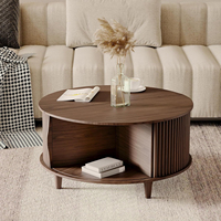 Table basse ronde en noyer avec rangement dissimulé et étagère inférieure, design côtelé moderne, idéale pour l'organisation du salon