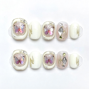 Ongles courts carrés-ovales faits à la main, effet papillon laser blanc, bordure dorée et cristaux, style français élégant et chic - Product Image 1