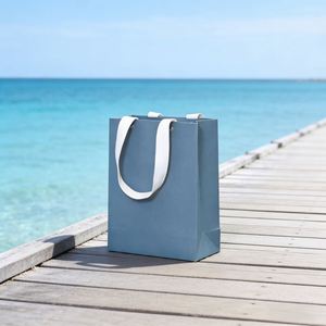 Sac en papier bleu pliable pour le commerce de détail, avec poignée en coton recyclé et design perforé à rivets, personnalisable - Product Image 2