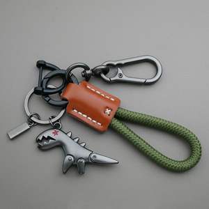 LLavero de aleación de <span class=keywords><strong>dinosaurio</strong></span> pequeño de dibujos animados transfronterizo chica coche cuero cosido a mano cuerda trenzada mochila colgante regalo - Product Image 6
