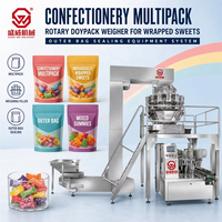Système d'emballage rotatif automatique pour confiseries en multipack, avec pesoir Doypack et scelleuse de sacs extérieurs pour bonbons emballés individuellement