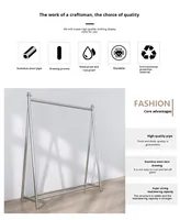 Expositor de ropa de acero inoxidable para tiendas, con barra de suelo y gancho para colgar, ideal para exhibición de ropa de niña.