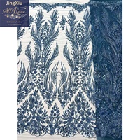 Tissu en dentelle africaine avec broderie de sequins rouges et motifs de plumes symétriques sur maille nude pour robes de soirée – Vente en gros