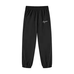 Siyah düz özel Logo açık spor rüzgarlık naylon pantolon naylon eşofman altları