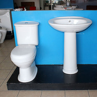 Ensemble WC deux pièces en céramique à poser au sol avec chasse d'eau, sanitaires en porcelaine, toilettes et lavabo sur colonne