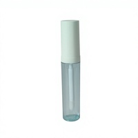 Tube de gloss à lèvres rond en plastique transparent avec applicateur magique et option de logo personnalisé pour l'emballage cosmétique