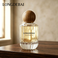 Venta al por mayor en stock: Botella de perfume de vidrio transparente con rayas verticales cilíndricas de 30ml, 50ml, 100ml, botella de perfume vacía con tapa de bola de madera.