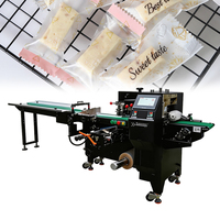 Machine d'emballage automatique industrielle multifonctionnelle de type coussin SZ-450 pour sachets plastiques, idéale pour l'emballage de produits alimentaires, snacks, bonbons et nougats.