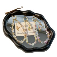 Belle chaîne de téléphone portable en cristal de luxe feuille d'or à la main perle courte chaîne de poignet papillon pendentif téléphone corde suspendue