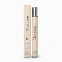 Parfum pour femme en roll-on, flacon givré, boîte dorée, miroir rond, intérieur boisé chaud, tenue longue durée