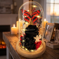 Nouvelle rose noire éternelle mystérieuse tendance dans un dôme en verre avec papillon rouge, cadeau romantique floral sombre pour elle