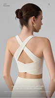Débardeur de yoga ajouré pour femme avec coussinets fixes, design push-up et absorbant les chocs, bretelles croisées