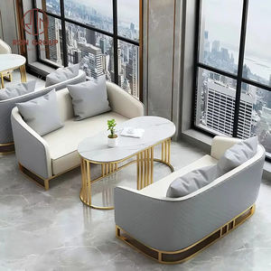 Ensemble de meubles de salle à manger moderne, table ronde en marbre avec base creuse dorée et quatre fauteuils gris pour café - Product Image 1