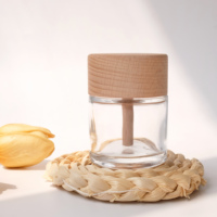 Flacon d'huile parfumée en verre transparent rond avec couvercle en bois pour l'aromathérapie