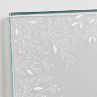 Plateau de table en verre trempé de sécurité avec un motif botanique sur le bord et un centre ouvert et épuré.