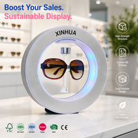 Présentoir à Lunettes Magnétique Flottant Rotatif Moderne en Plastique Poli avec Éclairage LED pour Personnalisation de Design