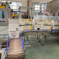 Botella de agarre robótica completamente automática/latas envolventes alrededor de caja de embalaje de cartón máquina de encuadernación línea de envasado de bebidas