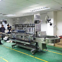 Machine de remplissage liquide automatique de haute précision pour les spiritueux et les cosmétiques en bouteille Garantie d'un an Ligne de production de remplissage