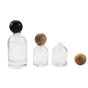 Wholesale luxury ball shaped lid clear spray bottle glass perfume bottle 50ml 100ml with sprayer