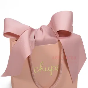 Tas kertas belanja perhiasan mewah Logo cetak kustom nosel emas Mini tas hadiah kertas merah muda lucu dengan pegangan penutup pita
