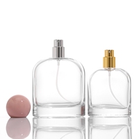 Vente en gros de flacons de parfum vides en verre transparent ovale de luxe de 50 ml et 100 ml avec atomiseur et couvercle sphérique
