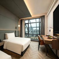 Ensemble de mobilier moderne pour chambre d'hôtel, appartement ou villa, en contreplaqué modulaire, comprenant meuble-lavabo, lit avec coffre et tête de lit, et bureau