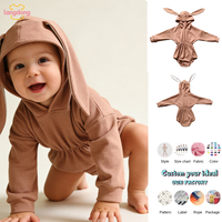 Vente en gros de combinaisons pour bébés à manches longues côtelées avec oreilles de lapin et queue de lapin en fourrure
