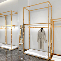 Présentoir à vêtements doré pour la vente au détail, table de présentation emboîtable, étagères à vêtements, présentoir de vêtements, mobilier pour magasin de vêtements