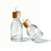 Flacon compte-gouttes rond en verre de luxe 30ml 50ml, flacon vide transparent pour sérum et huile essentielle avec bouchon compte-gouttes en bois pour emballage cosmétique