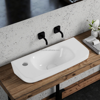 Vente en gros de lavabo long en céramique blanche au design moderne, rond, simple lavabo pour salle de bain, facile à nettoyer, installation au-dessus du comptoir