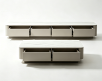 Ensemble moderne de meuble TV et table basse en pierre frittée, avec coins arrondis et rangement intégré pour salon