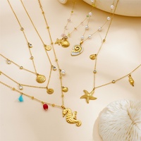 Collier en acier inoxydable plaqué or avec breloques coquillage, étoile de mer et conque, perle, pour femme, idéal pour les vacances à la plage - Vente en gros de bijoux en acier inoxydable