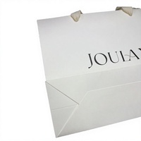 Sacs en papier blancs de qualité supérieure avec logo personnalisé, poignée en corde de coton, logo imprimé UV noir pour l'emballage de vêtements et de bougies