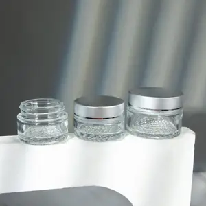 Hot sale refillable travel use mini glass cosmetic face cream container, 30ml 50ml 100ml clear glass jar with silver lid