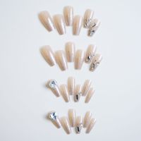 Faux ongles à presser rose nude forme cercueil avec pointes françaises à paillettes argentées et accents de cristaux pour soirées romantiques