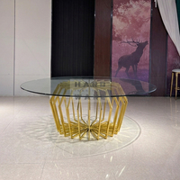 Table de salle à manger moderne pour hôtel avec plateau en verre rond et structure en acier inoxydable pour les événements de mariage et de banquet