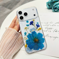 Coque antichoc transparente en TPU avec fleurs bleues séchées et paillettes pour iPhone 17, 16, 16e, 15, 14 Plus, 13, 12, 11 Pro Max