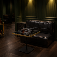 Banquette de restaurant rétro en cuir noir, table en pierre frittée avec base en fonte pour ensemble de mobilier de café