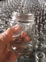 Bocal en verre rond vide avec couvercle métallique transparent pour le stockage du miel, de la confiture et des cornichons
