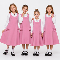 Robe d'uniforme scolaire de haute qualité pour filles, sans manches, à volants et poches, avec bretelles, logo personnalisé, vente en gros OEM ODM